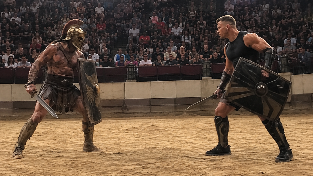 An ancient Roman gladiator faces a modern sports-science-trained fighter in a contemporary arena.